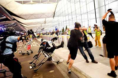直击｜香港机场瘫痪两天，现场出现美国国旗